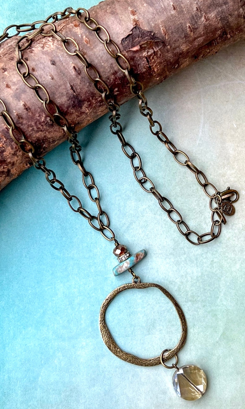 Long necklace with circle pendant with stone detail 