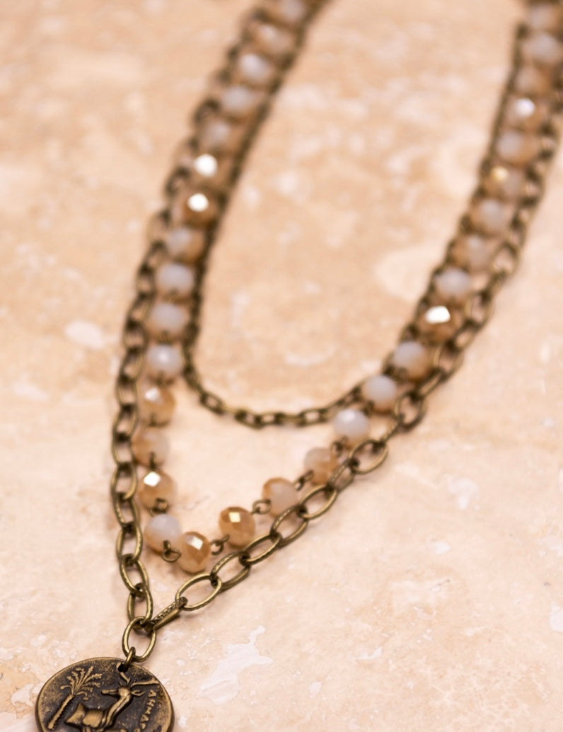 chain and beaded 3 chain necklace with a brass pendant 