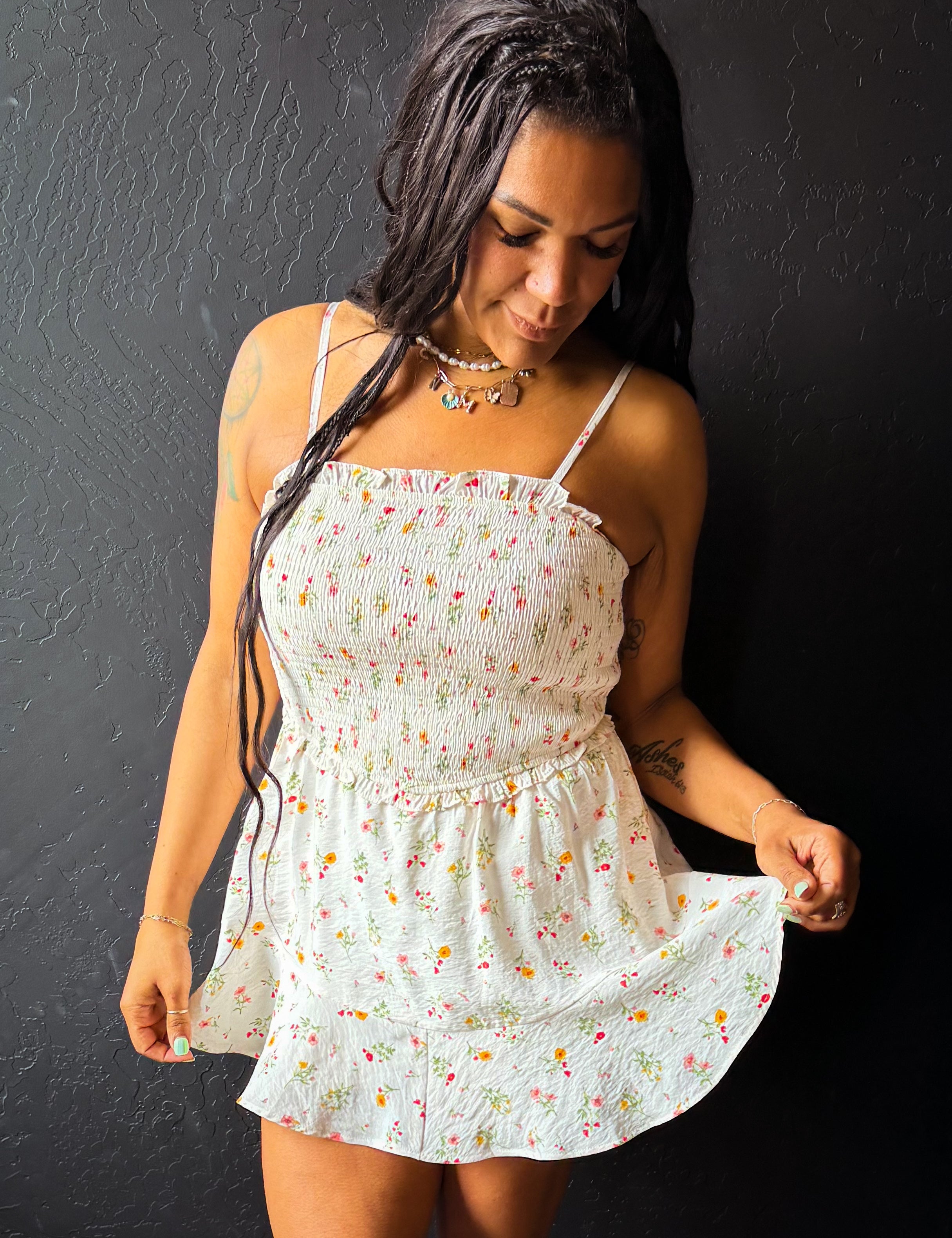 Woman wearing a floral dress against a dark background