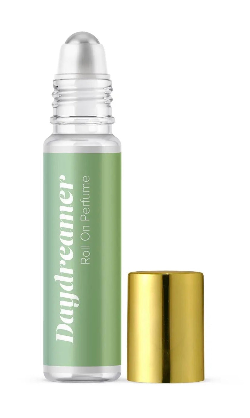 Roll-on perfume bottle with green label and gold cap on white background