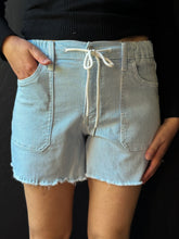 Light blue striped shorts with a drawstring on a black background