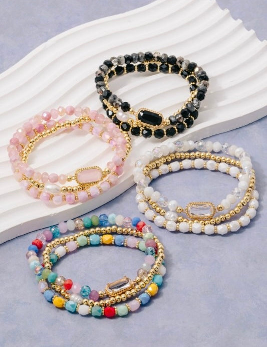 Set of beaded bracelets on a light gray background