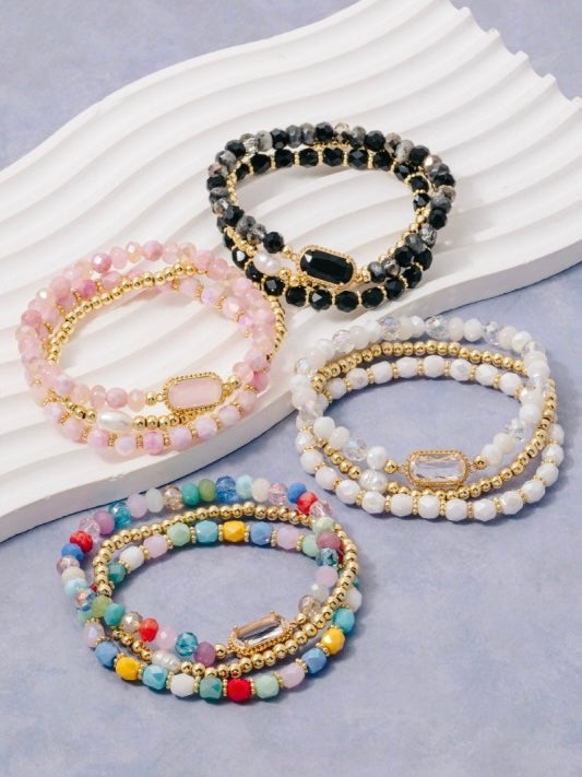 Set of beaded bracelets on a light gray background