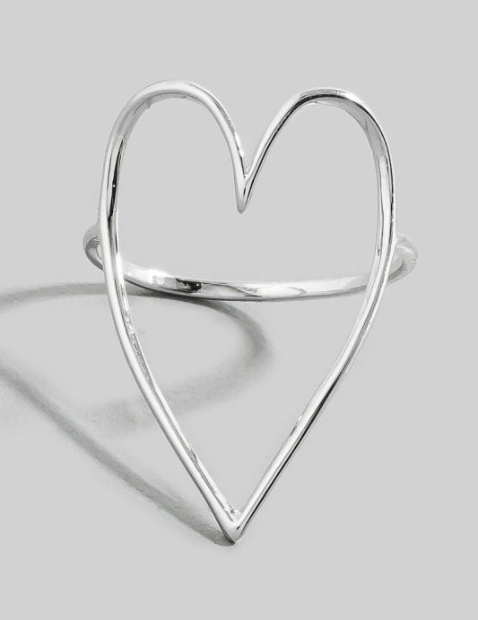 Silver heart-shaped ring on a light gray background