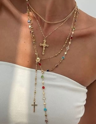 Necklace with cross pendants and colorful beads on a white background