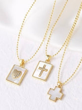 Three gold necklaces with pendant charms on a white background