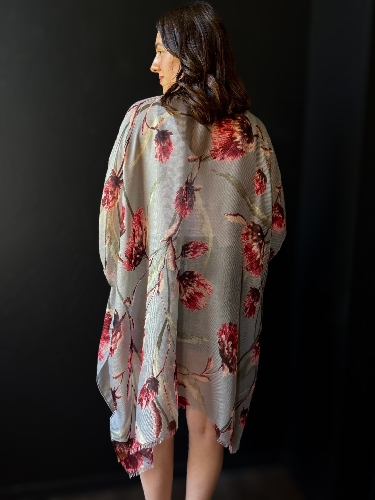Woman wearing a floral kimono against a black background
