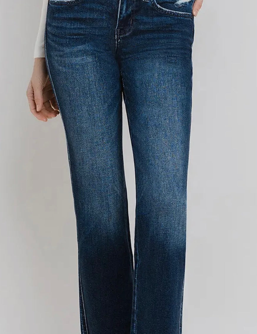 Blue jeans worn by a person on a white background