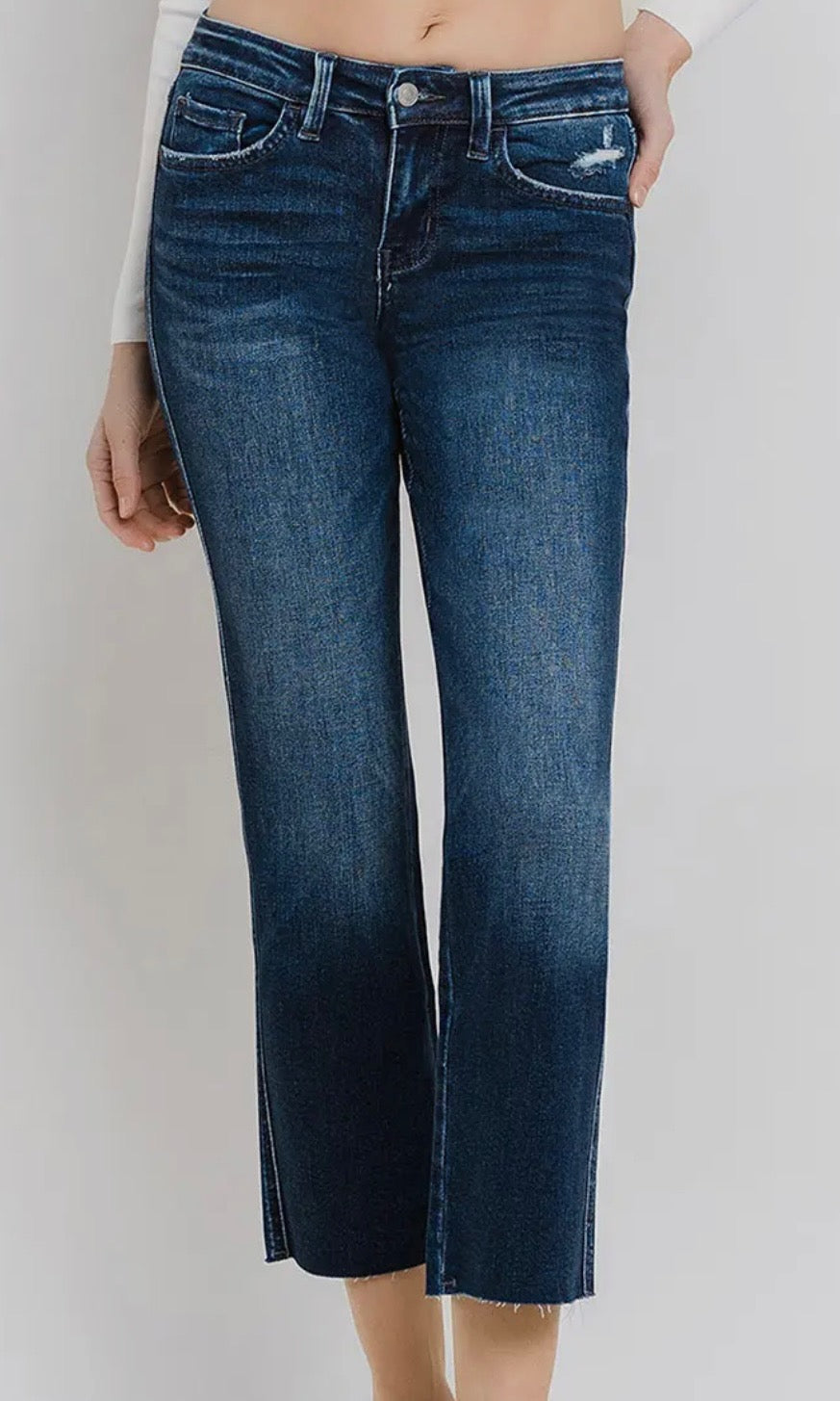Blue jeans worn by a person on a white background