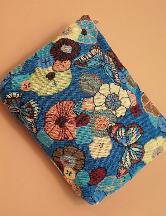 Folded fabric with floral and butterfly pattern on a beige background