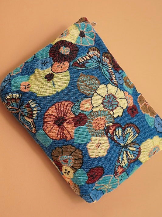 Folded fabric with floral and butterfly pattern on a beige background