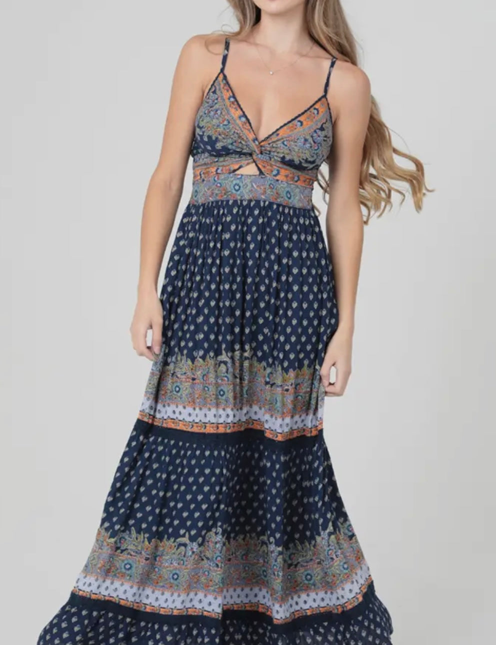 Woman wearing a patterned dress on a plain background