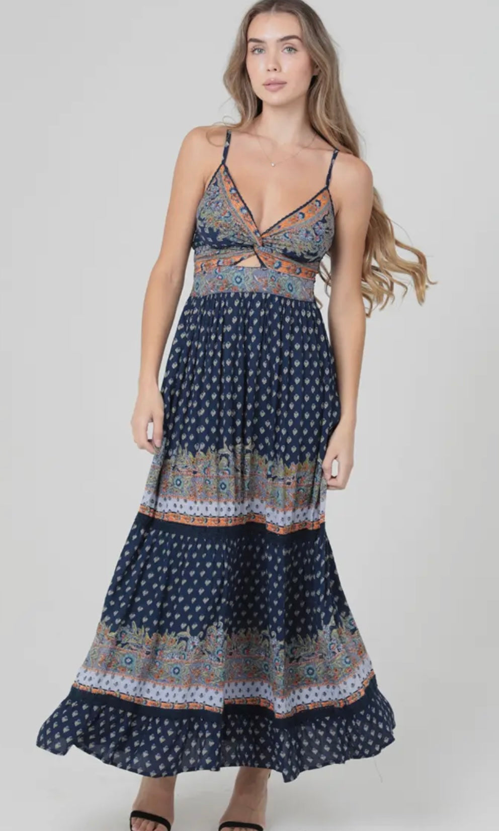 Woman wearing a patterned dress on a plain background