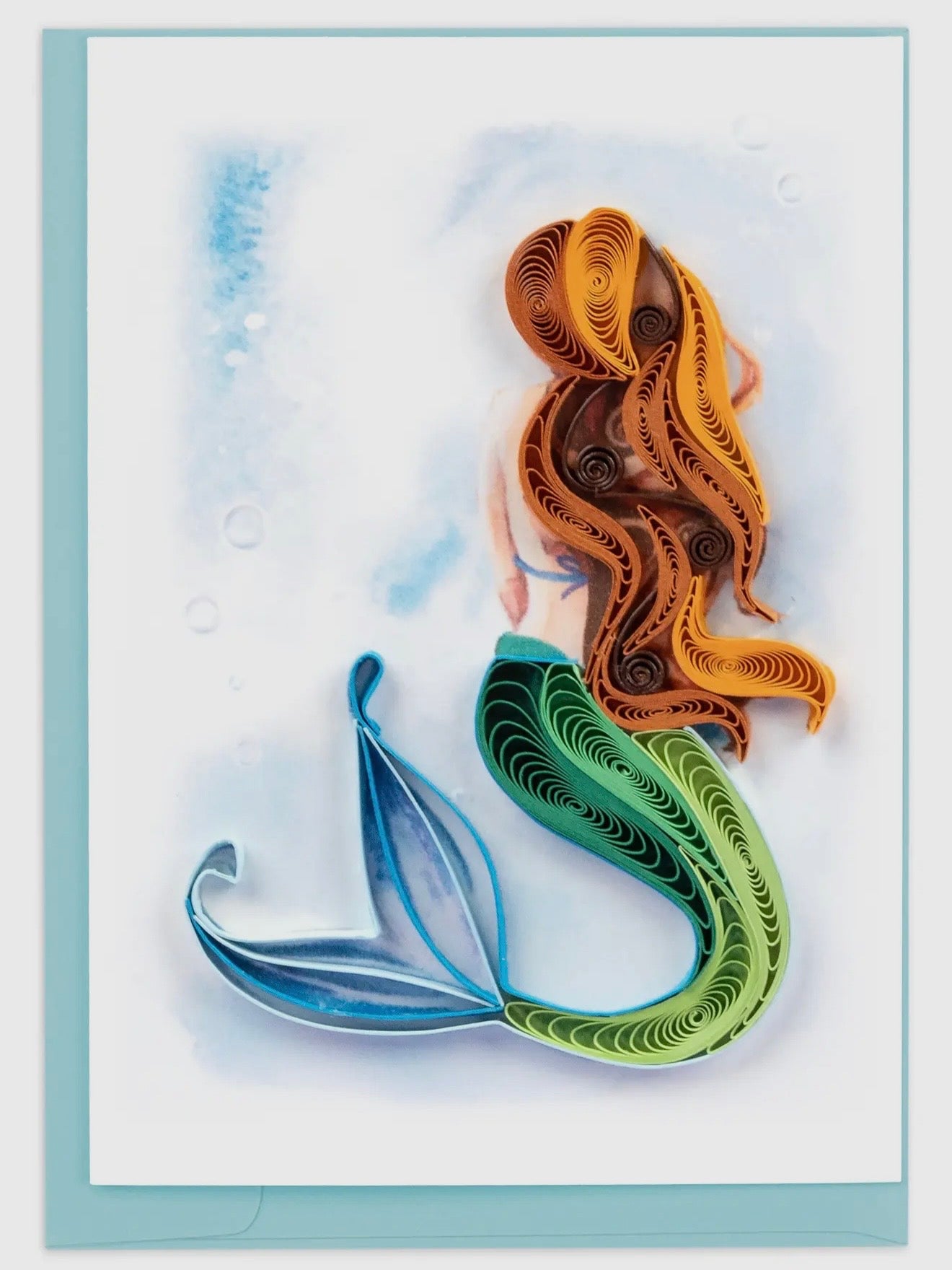 Quilled mermaid figure with brown hair and green tail on a light blue background