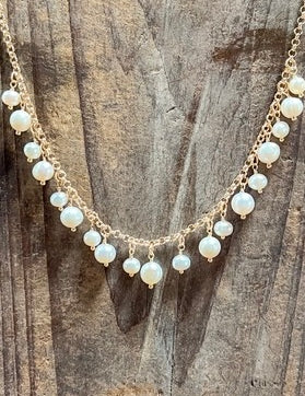 Pearl necklace on a wooden surface