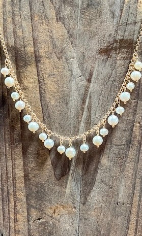 Pearl necklace on a wooden surface