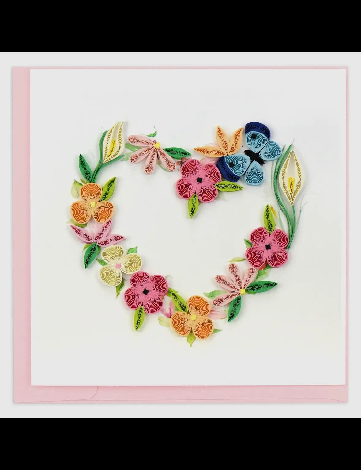 Heart-shaped arrangement of colorful flowers on a white background with a pink border.