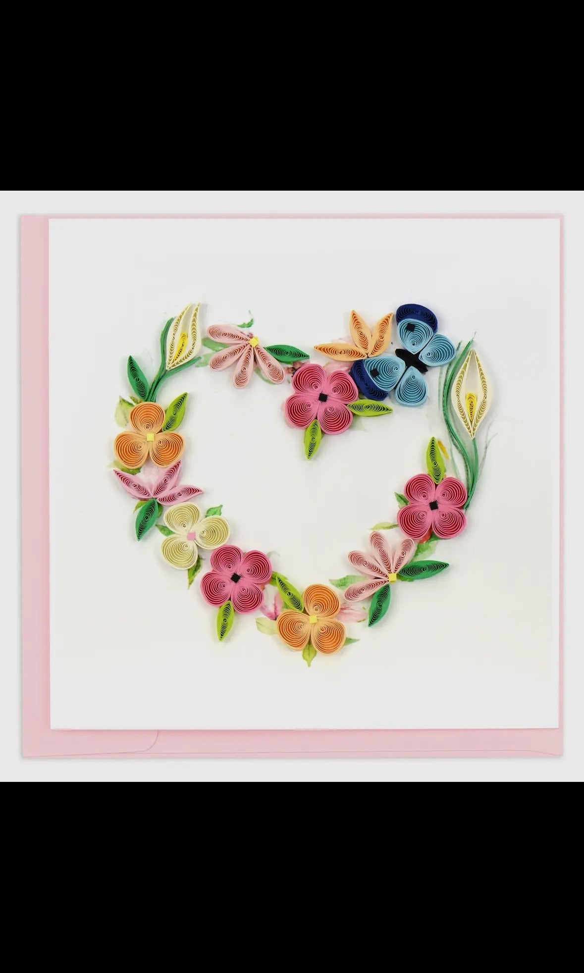 Heart-shaped arrangement of colorful flowers on a white background with a pink border.