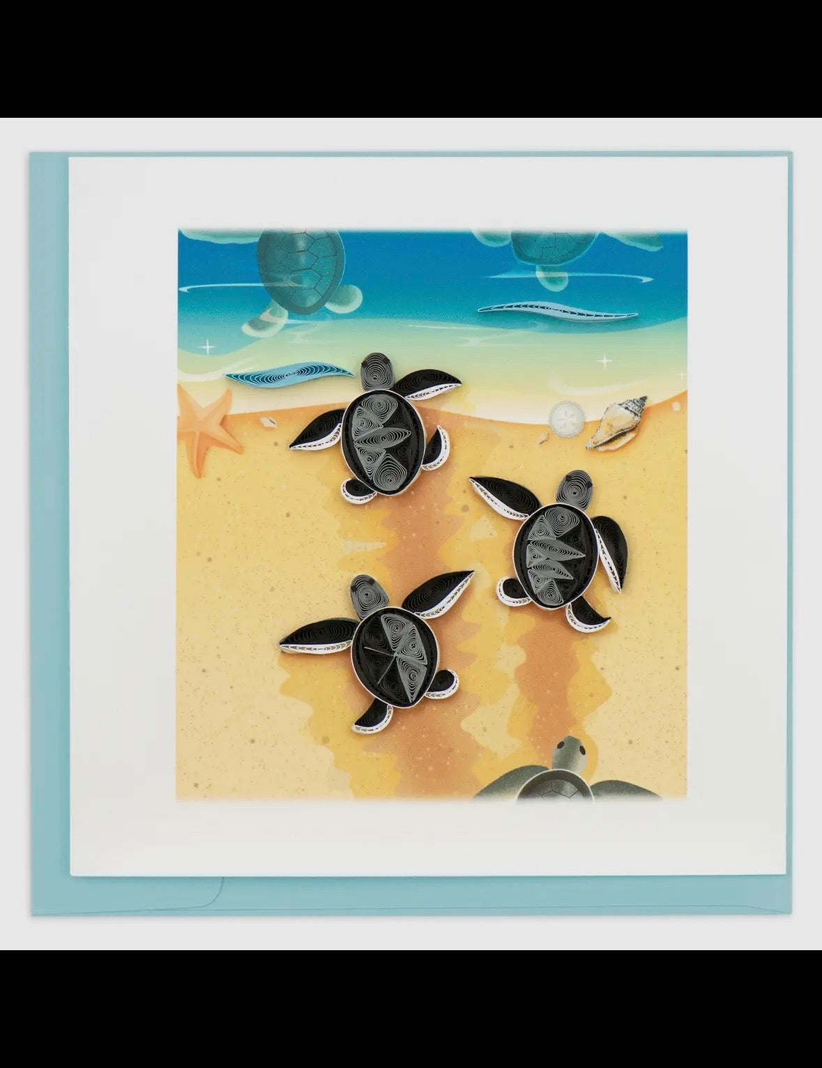 Framed artwork of turtles on sand with ocean background