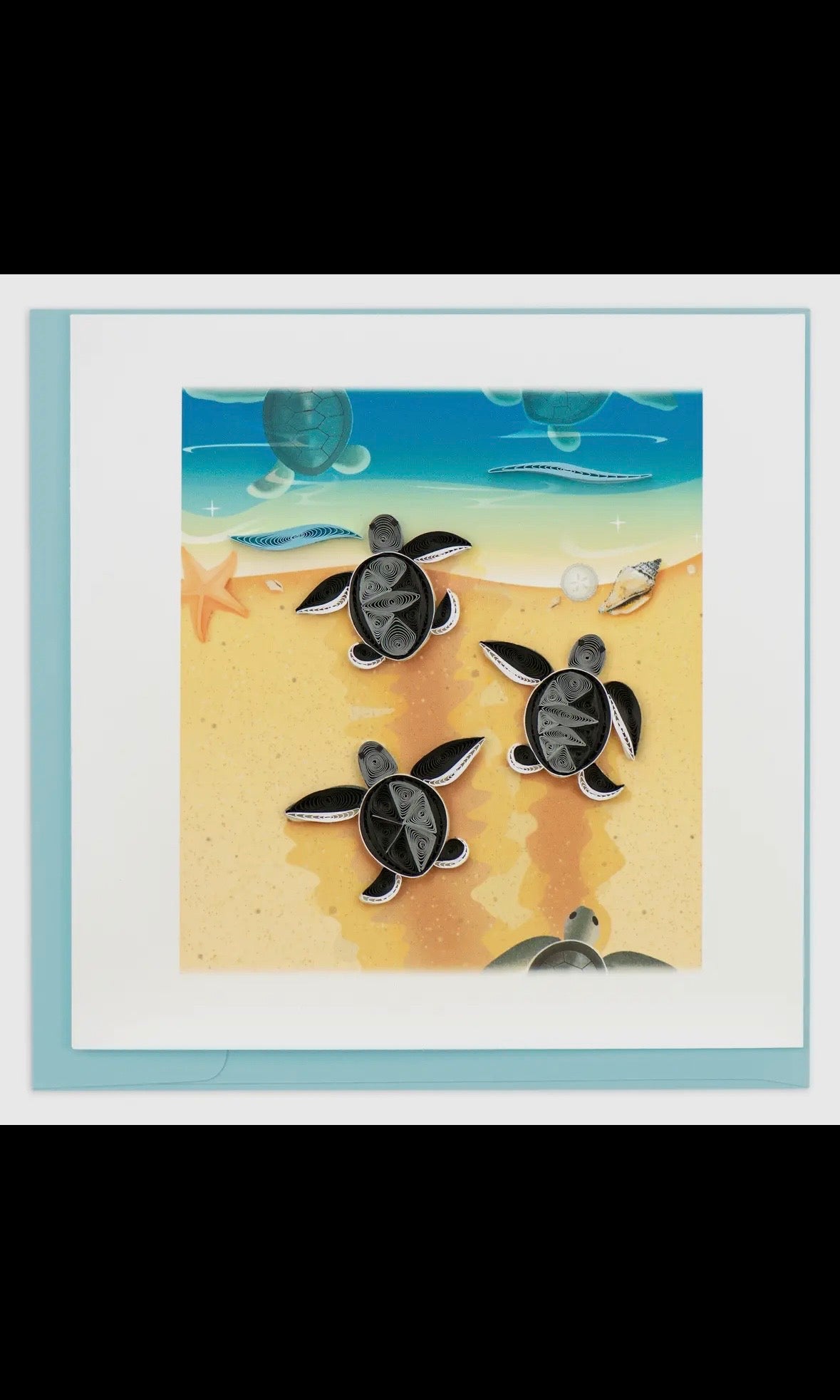 Framed artwork of turtles on sand with ocean background