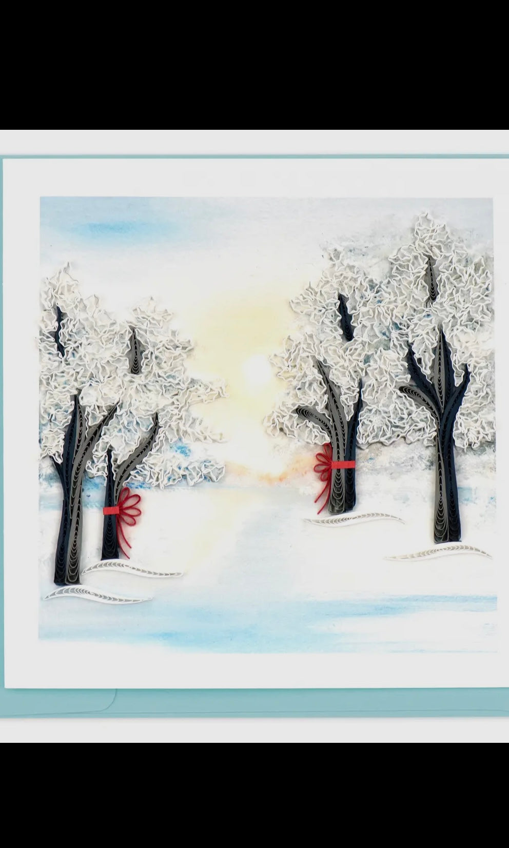 Winter scene with trees and snow, featuring a red object in the snow.