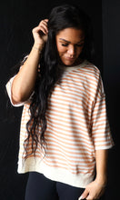 Woman wearing a striped shirt against a black background