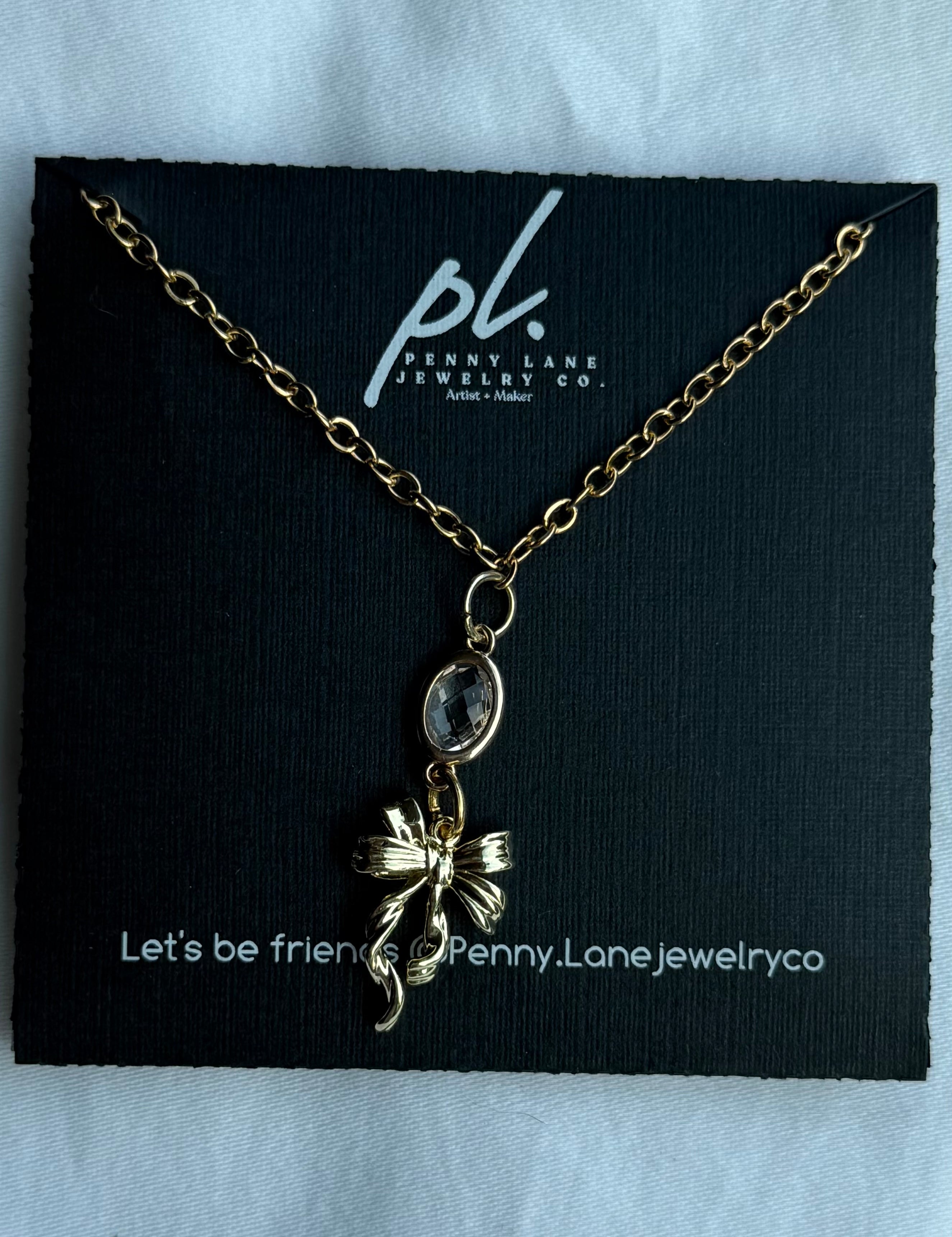 Necklace on a Penny Lane Jewelry Co. card with a black background
