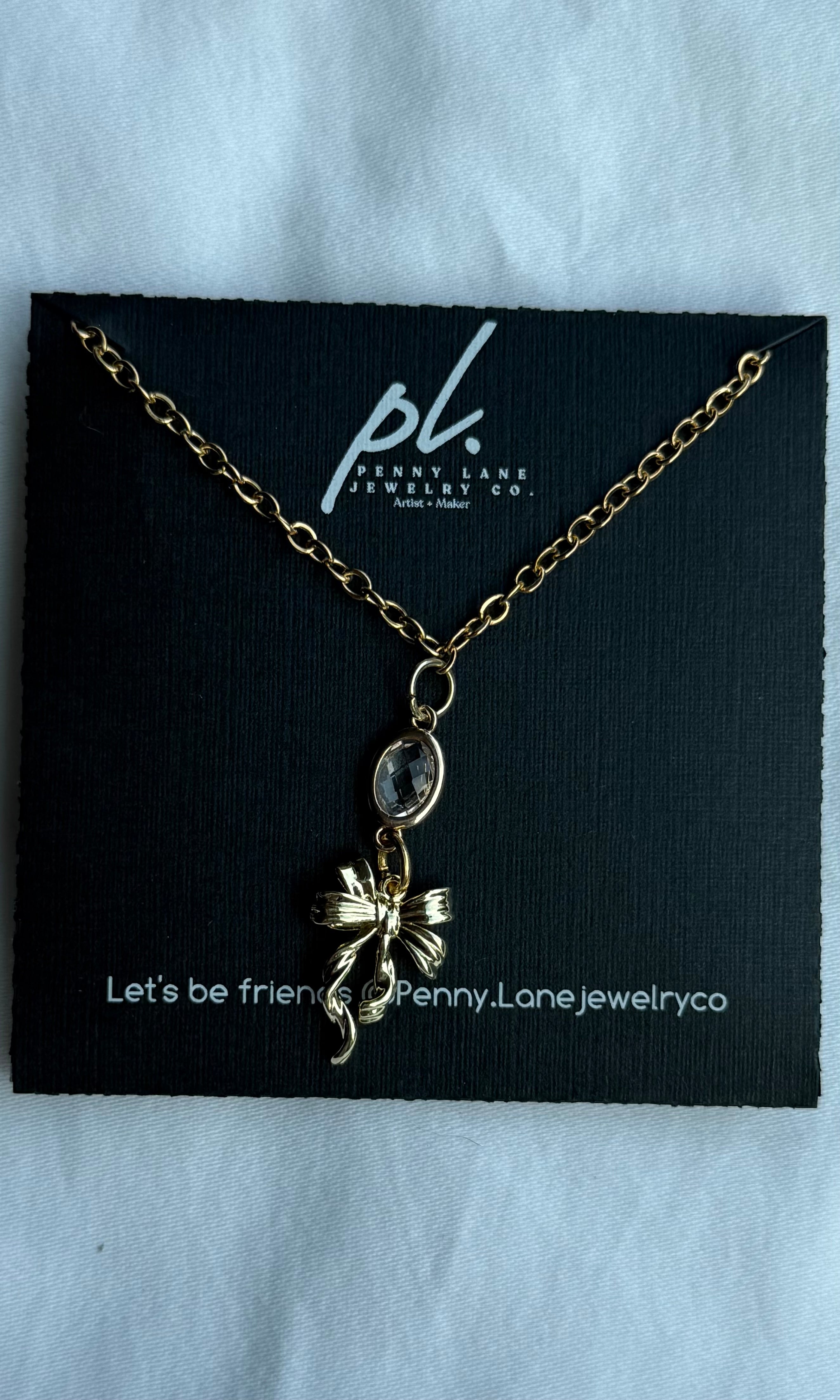 Necklace on a Penny Lane Jewelry Co. card with a black background