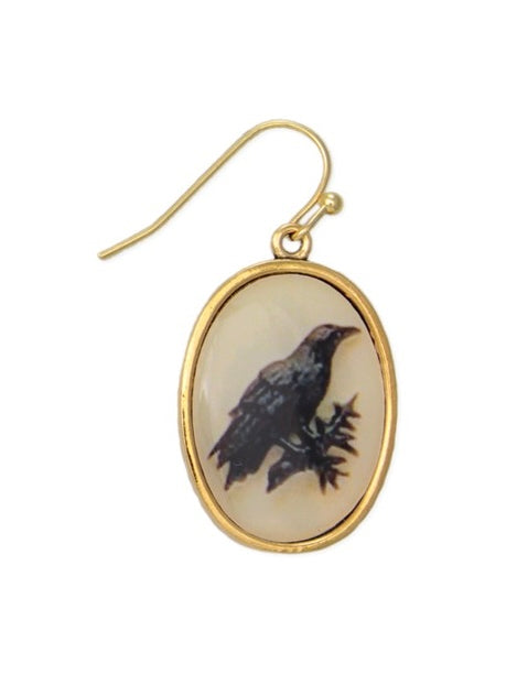 Gold oval earring with a bird design on a white background