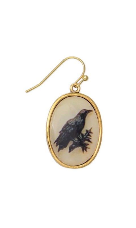 Gold oval earring with a bird design on a white background